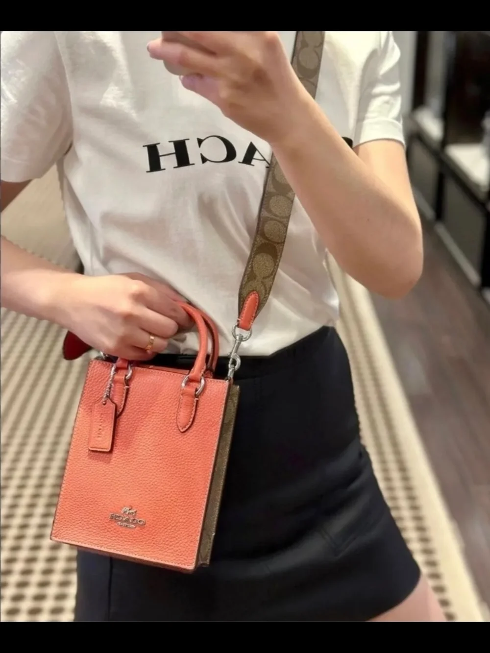 Coach Pebbled Leather Crossbody Phone Bag in Coral with Signature Strap